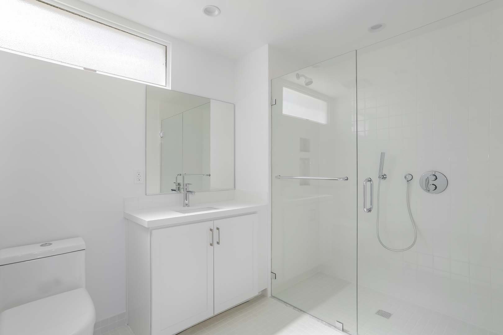 Culver City CA Apartments for Rent - Sleek and Modern Bathroom with White Interiors and Shower with Glass Door