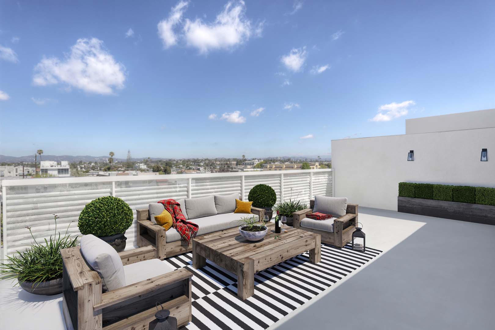 Apartments for Rent in Culver City - The Lucky - Rooftop Sitting Area with Comfy Chairs and Wooden Table
